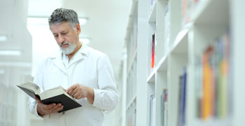 Doctor reading book in medical library